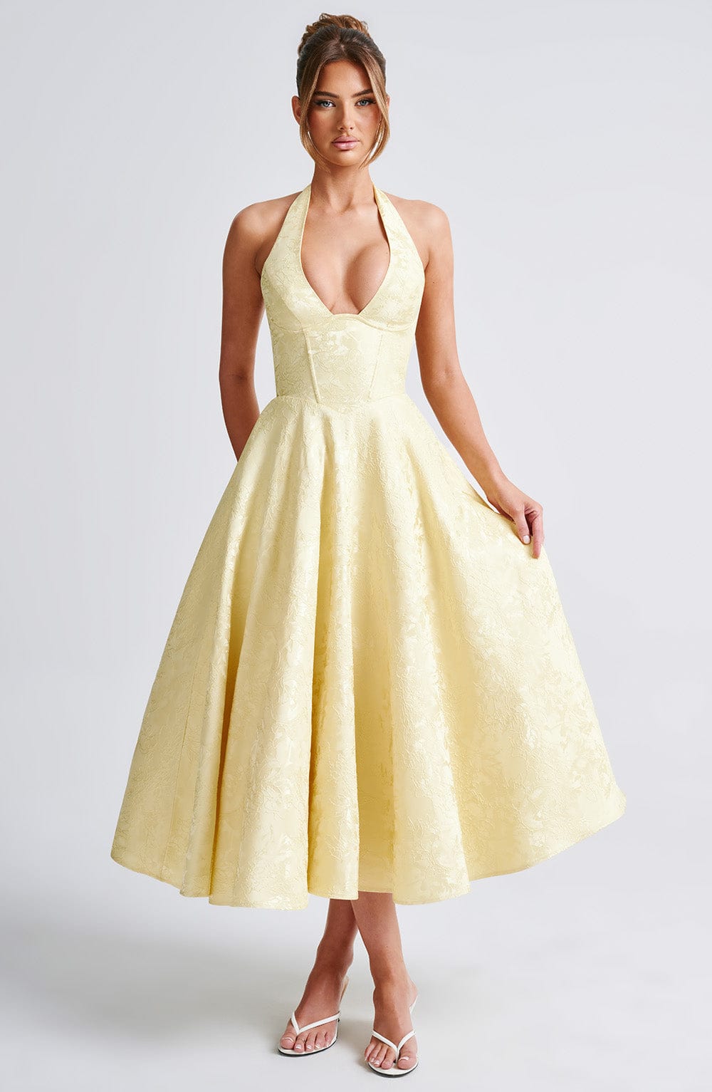 White elegant halter neck midi dress, a perfect wedding guest attire for women.