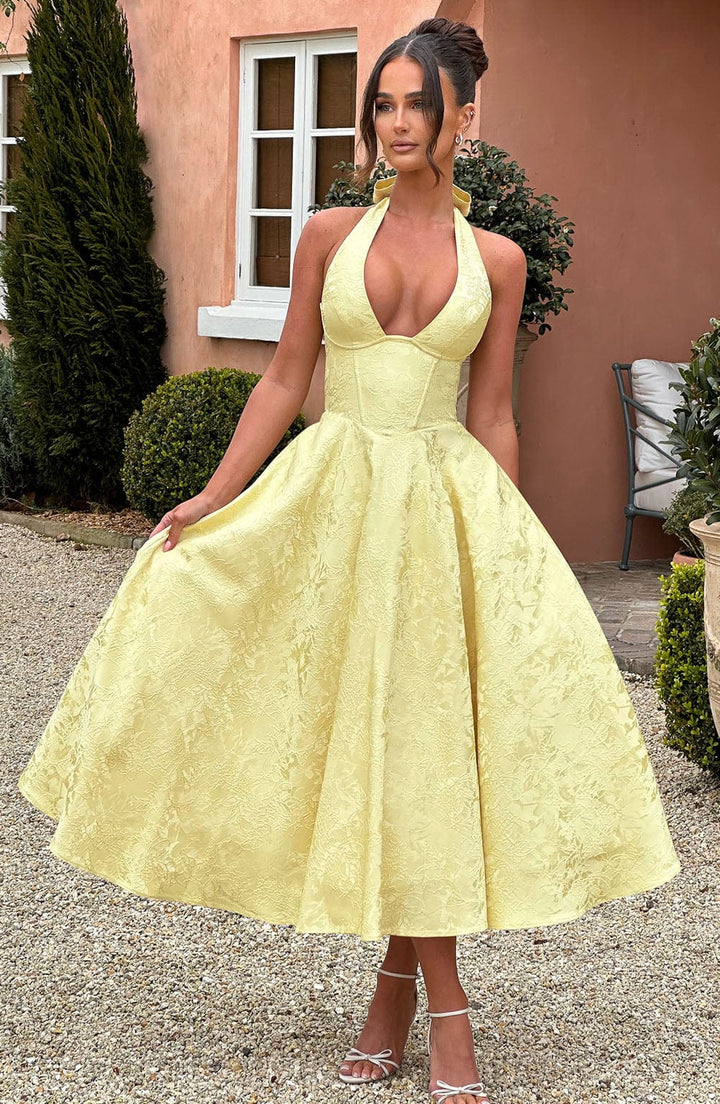 Stylish halter neck on an elegant pink midi dress, a sophisticated women's fashion piece.