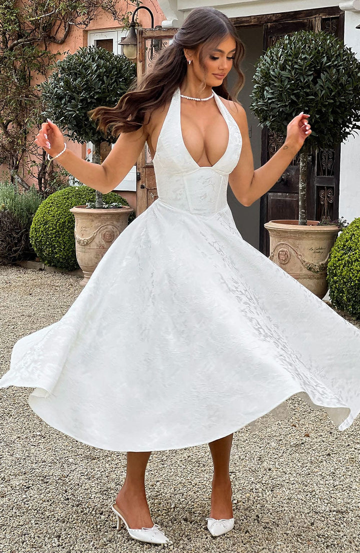 Textured fabric detail of the elegant white halter neck midi dress for women.