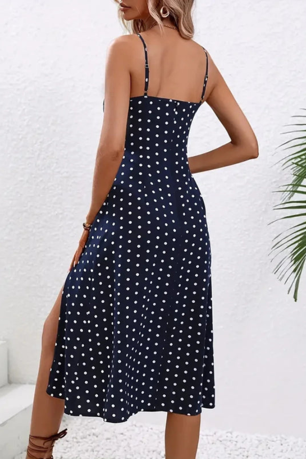 Flowy floral pleated halter neck midi dress. Women's elegant sleeveless design for summer events.
