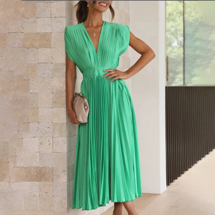 Women's elegant midi wedding guest dress, featuring a V-neck and delicate pleats.