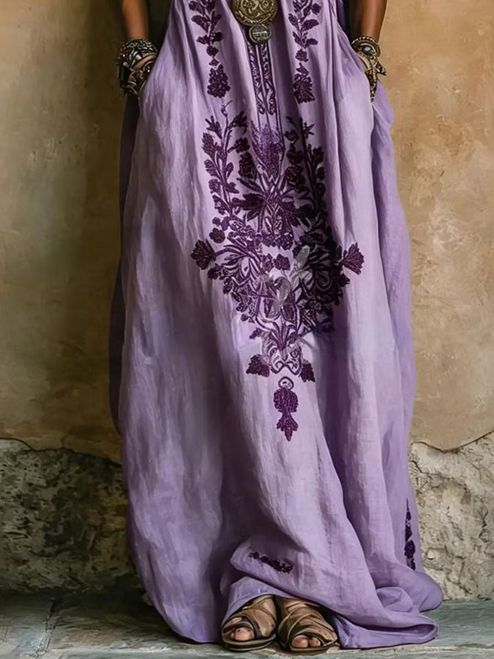 Women's v-neck purple embroidered kaftan dress. Elegant flowing maxi style with batwing sleeves for comfort.