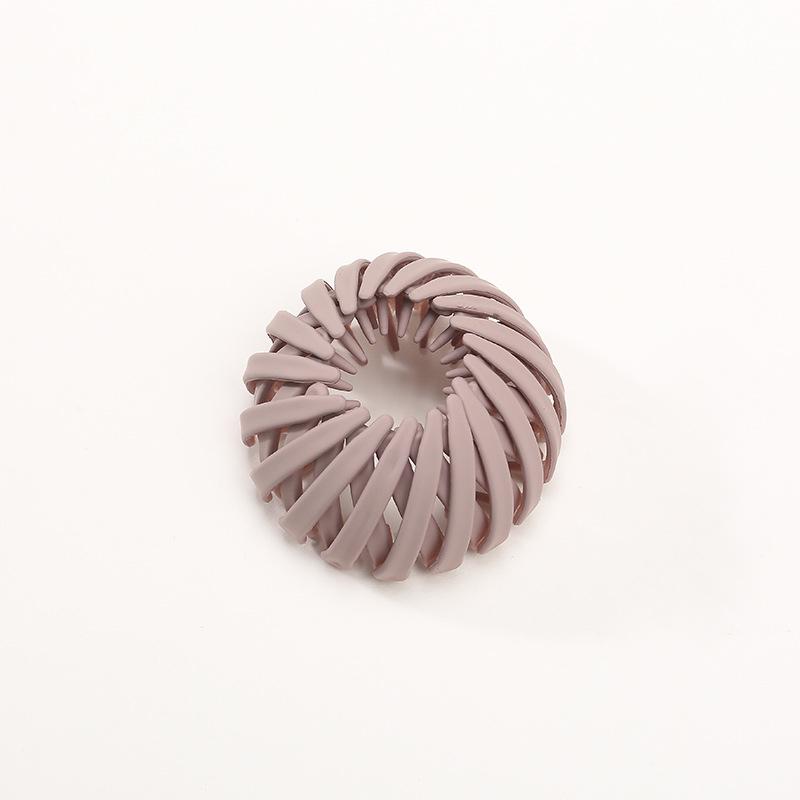 Model showcasing an instant elegant bun created with a women's hairpin, chic and effortless