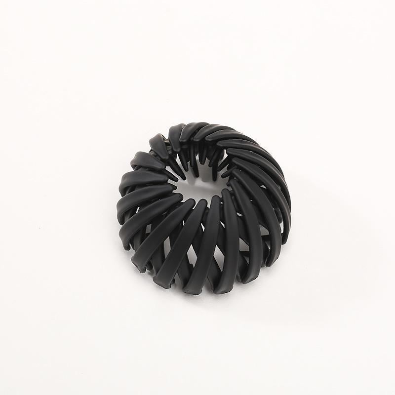Detailed view of the women's instant elegant bun hairpin, highlighting its smooth resin finish