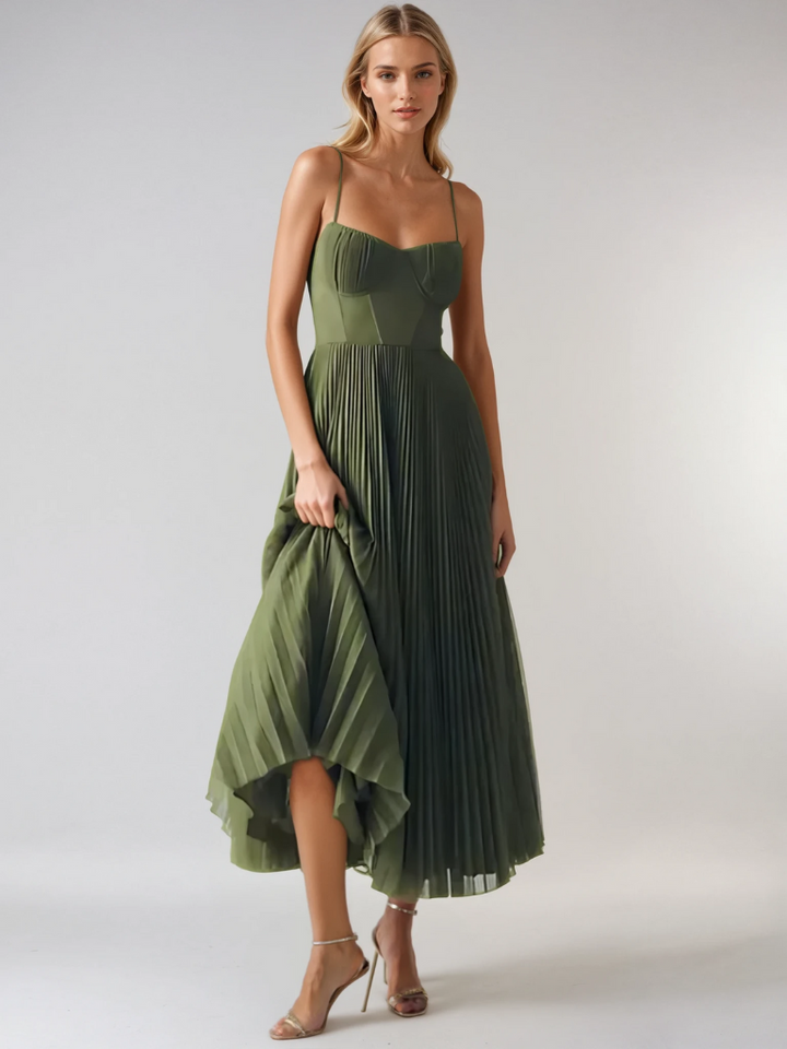 Fashionable women's wedding guest dress: sage green pleated maxi with elegant corset details.