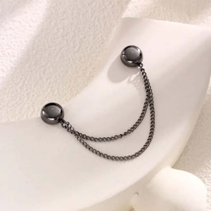 Gold-toned magnetic clothing clip with an intricate etched design, adding a touch of elegance to any outfit.