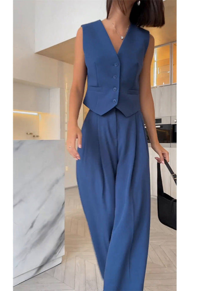 Close-up of elegant women's sleeveless blazer & slim pants fabric. High-quality professional two-piece set.
