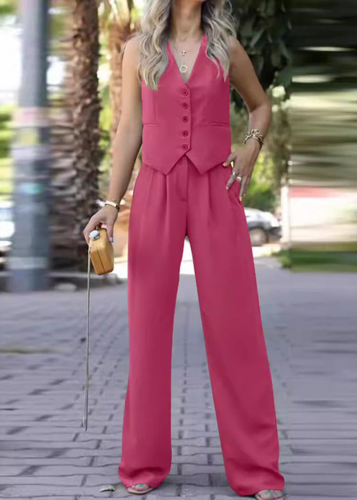 Full length view of a woman wearing an elegant sleeveless blazer & slim pants suit. Business fashion.