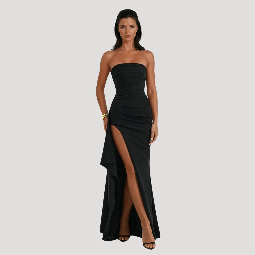 Flowing strapless maxi dress in navy blue, ideal for a sophisticated wedding guest or evening wear.
