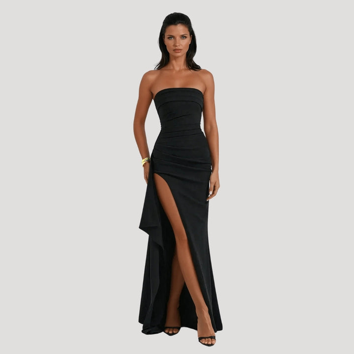 Flowing strapless maxi dress in navy blue, ideal for a sophisticated wedding guest or evening wear.