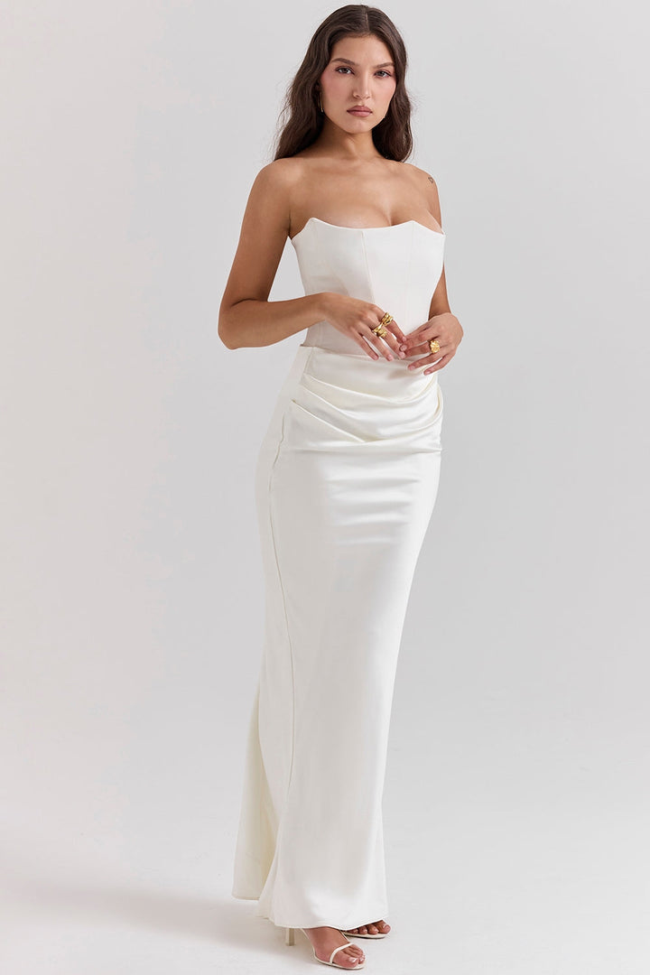 Cream-colored strapless maxi dress, offering an elegant look for a wedding guest or special occasion.