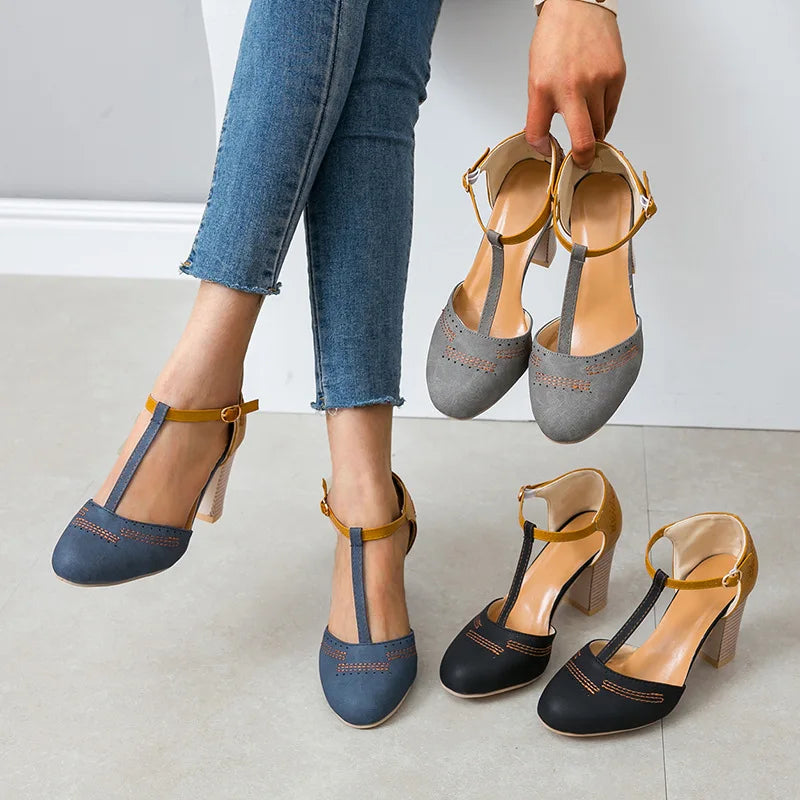 Pair of women's two-tone block heel shoes, offering comfort and style in elegant strap heels
