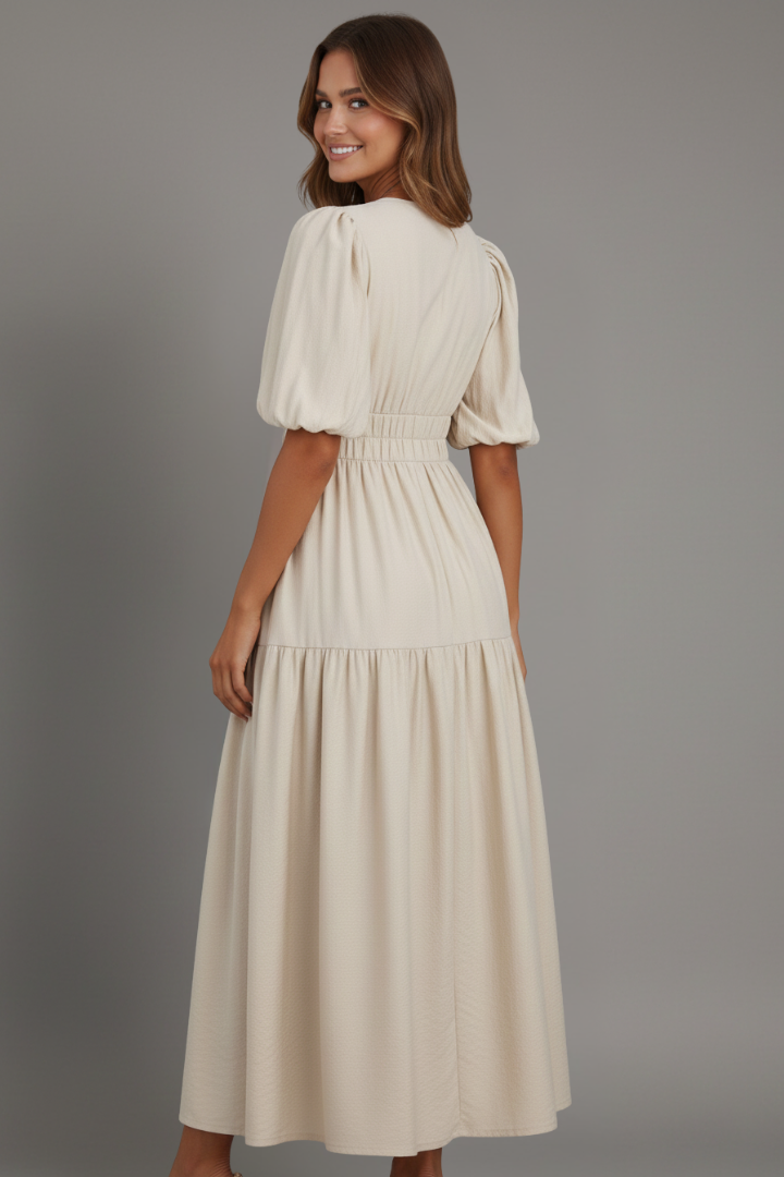 Chic women's V-neck midi dress, designed with a graceful flowing tiered hem for an elegant silhouette.