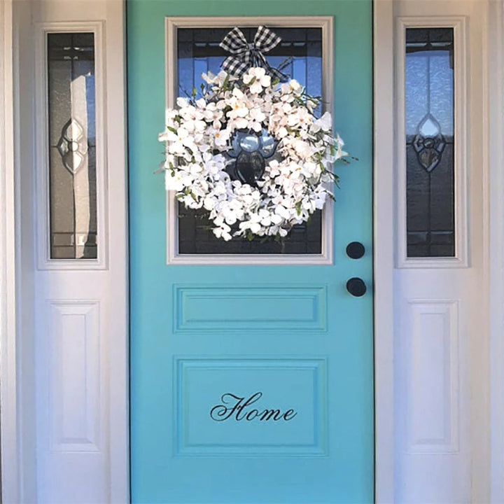 Beautiful artificial dogwood floral wreath with white blossoms for seasonal home decor.