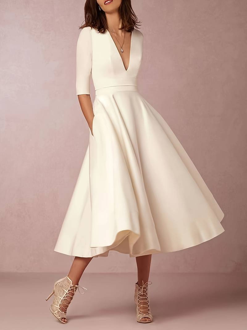 Women's white flared midi dress, suitable for wedding guest attire or sophisticated party wear.