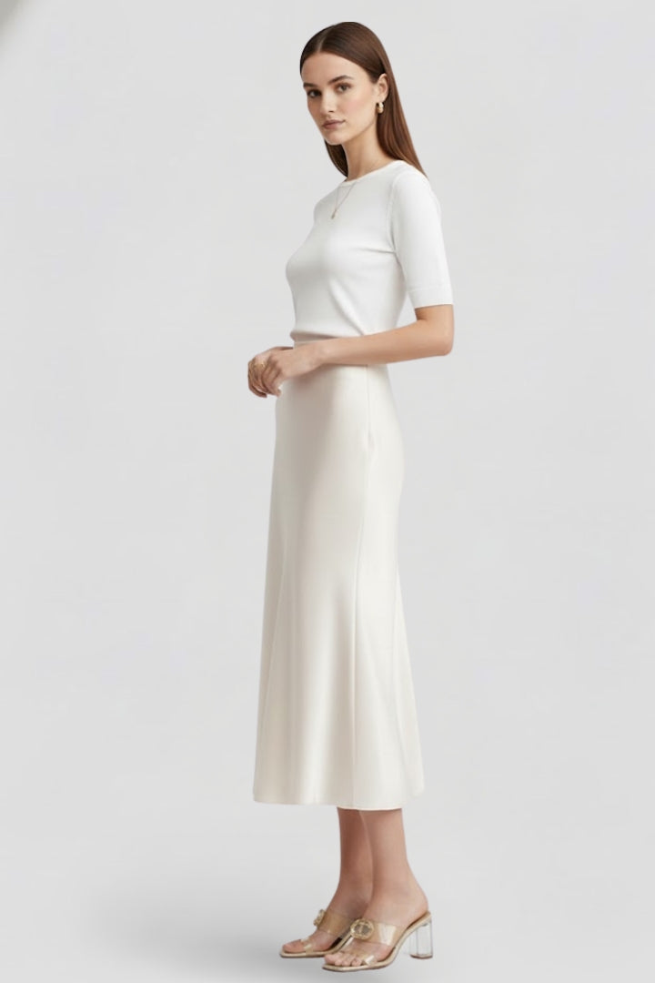 Fashionable white high-waisted draped midi skirt, an elegant and versatile addition to women's wardrobe.