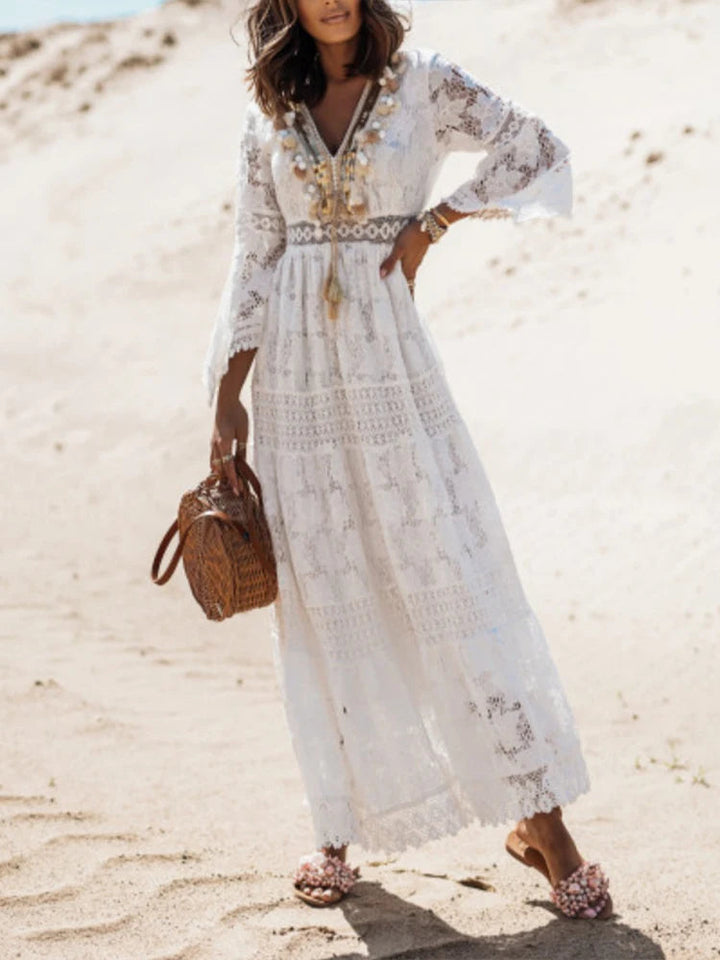 Elegant white V-neck tiered maxi dress for women, perfect for evening or party wear. Flowy long sleeve fashion.