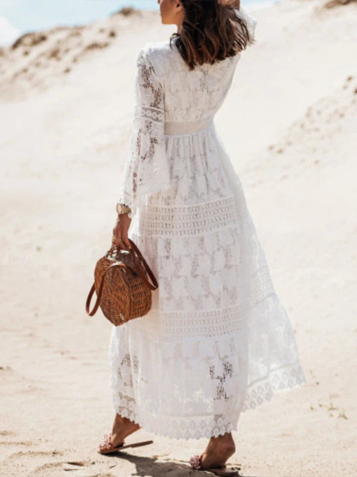 Flowy white V-neck tiered maxi dress for women. Elegant long sleeve design, perfect for versatile fashion.