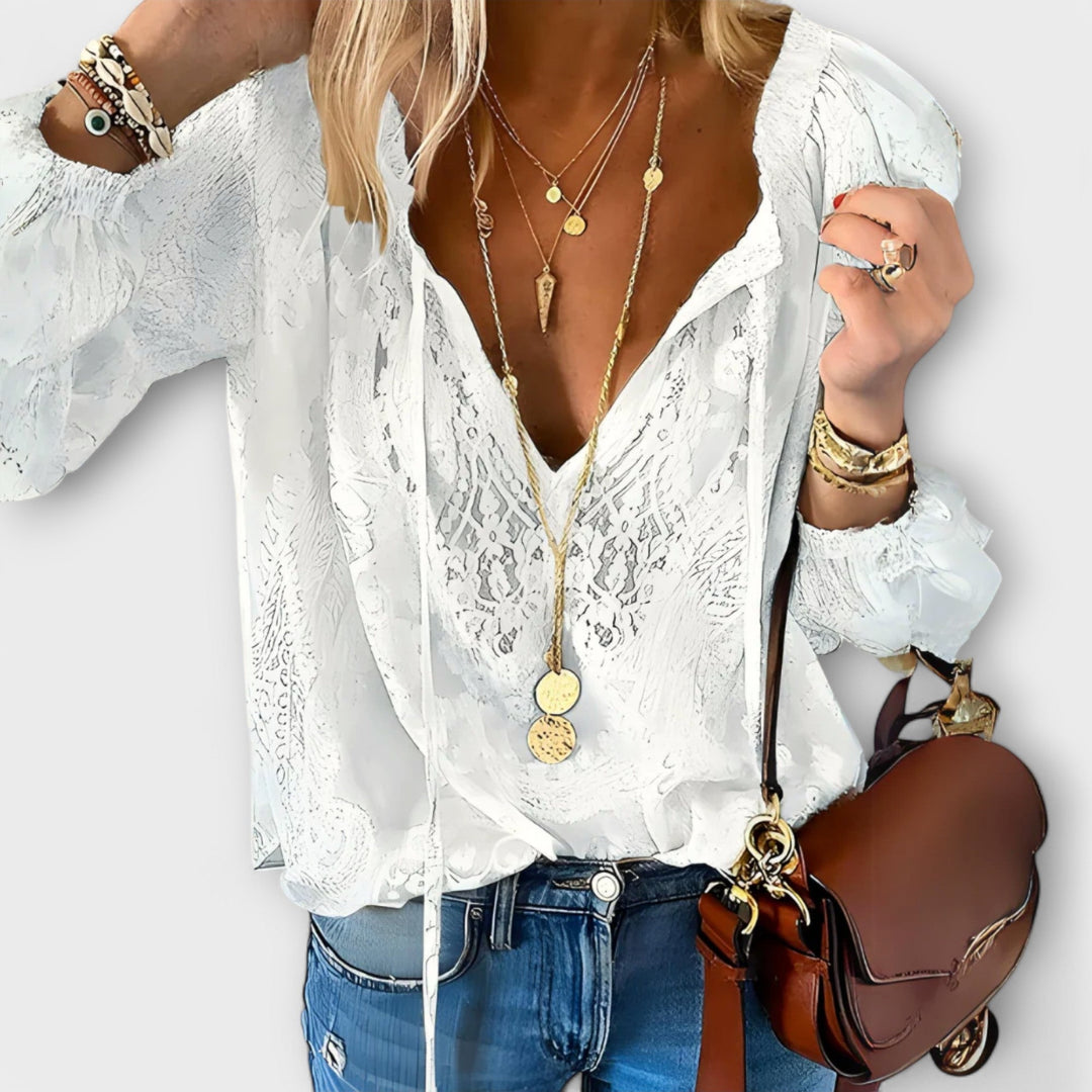Elegant white women's blouse with delicate tie-neck details, perfect for sophisticated casual chic outfits.