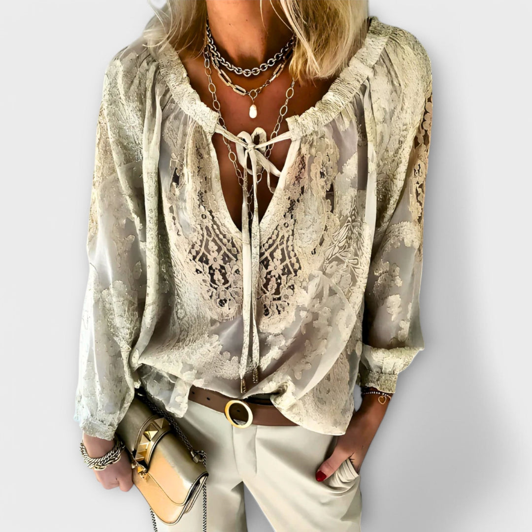 Sophisticated black women's blouse, featuring a stylish tie-neck & delicate details for versatile elegant wear.