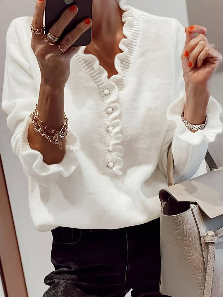 Elegant white women's ruffle blouse with decorative buttons, long sleeves, perfect for spring fashion.