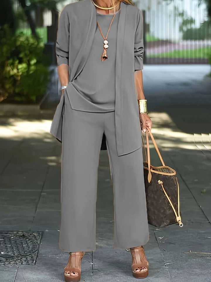 Fashionable women's 3-piece outfit: open-front duster, wide-leg trousers, & tank top. Elegant & comfy.
