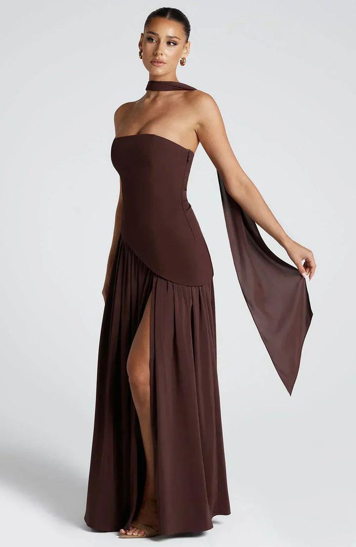 Close-up of the textured fabric on an elegant women's asymmetric maxi wedding guest dress.
