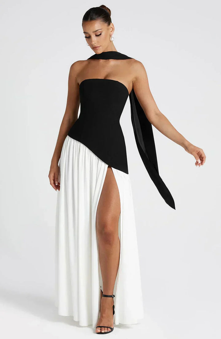 Close-up of the elegant bodice and asymmetric hem of a women's maxi wedding guest dress.