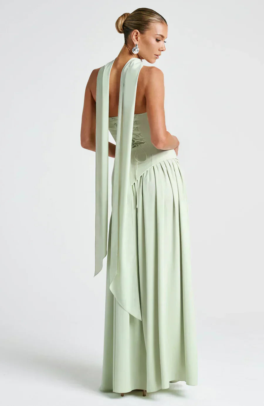 Model posing in a sophisticated silver grey asymmetric maxi dress, perfect for wedding guests.