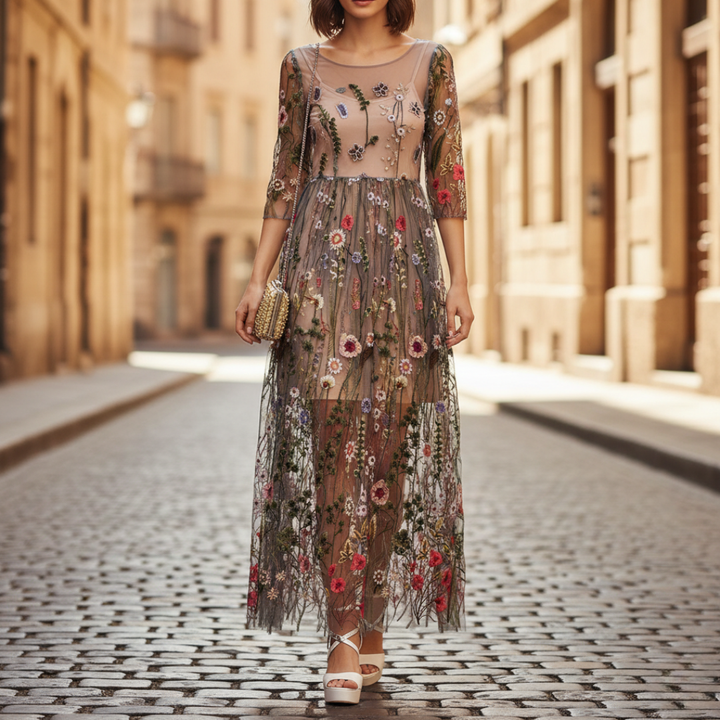 Elegant women's beige maxi dress with delicate floral embroidery, three-quarter sleeves, and a round neck. Perfect for formal occasions.