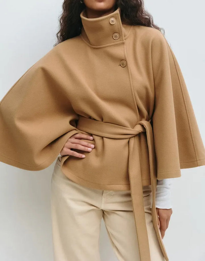 Elegant women's belted high-neck cape coat in a light color, perfect for spring outerwear fashion.