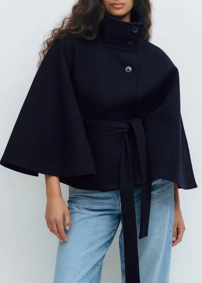 Fashionable women's high-neck cape coat, cinched at the waist with a belt, ideal for elegant spring days.