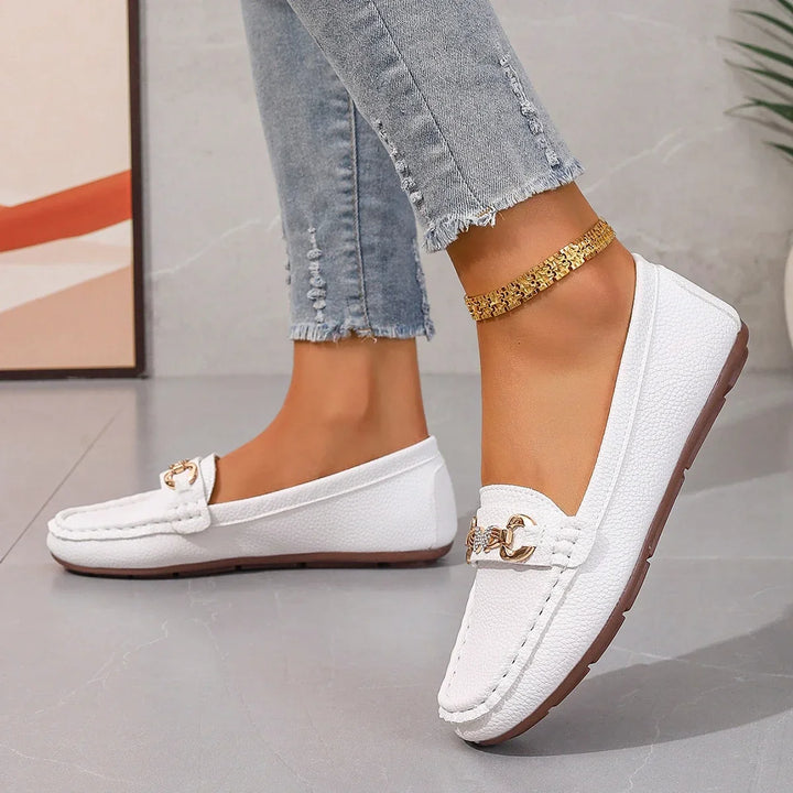 Dressy women's black loafers with a shimmering crystal chain, versatile for various outfits.
