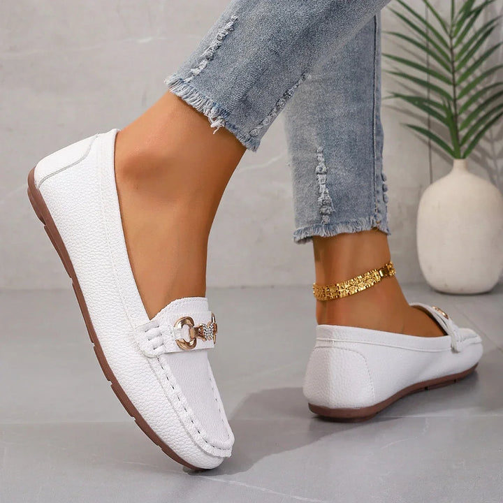 Stylish women's slip-on loafers, faux leather construction with unique crystal chain design.