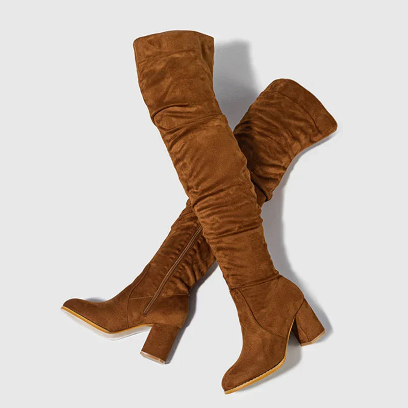 Side profile of women's elegant heeled over-the-knee boots, showing the heel height and shape
