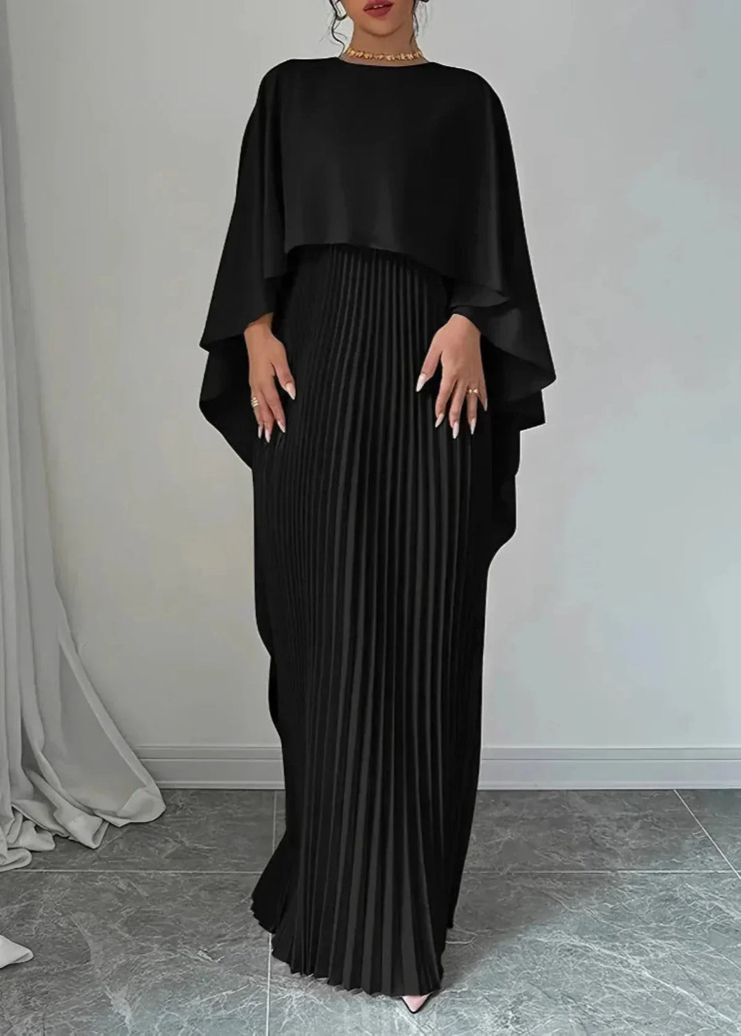 Long, elegant women's pleated maxi dress with a sophisticated cape overlay, perfect formal wear for events.
