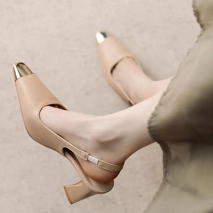 Top-down view of women's black block heel slingbacks, showcasing pointed toe and metallic accent