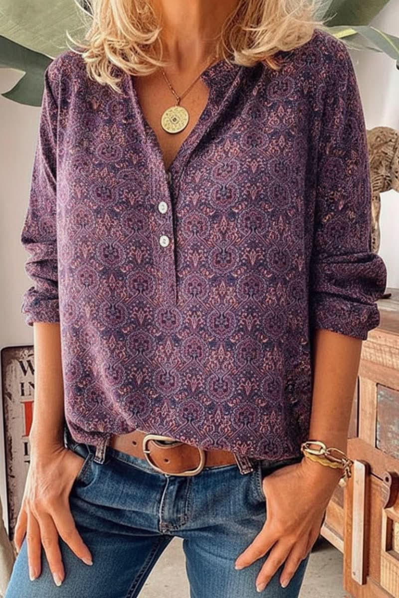 Women's long sleeve blouse featuring an elegant vintage print design. Stylish button-front top for fashion-forward women.