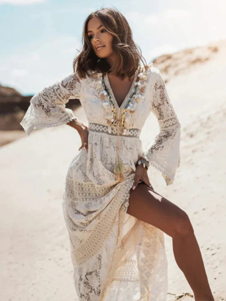 Detailed close-up of a women's bohemian lace maxi dress, highlighting intricate lace patterns & romantic flared sleeves.