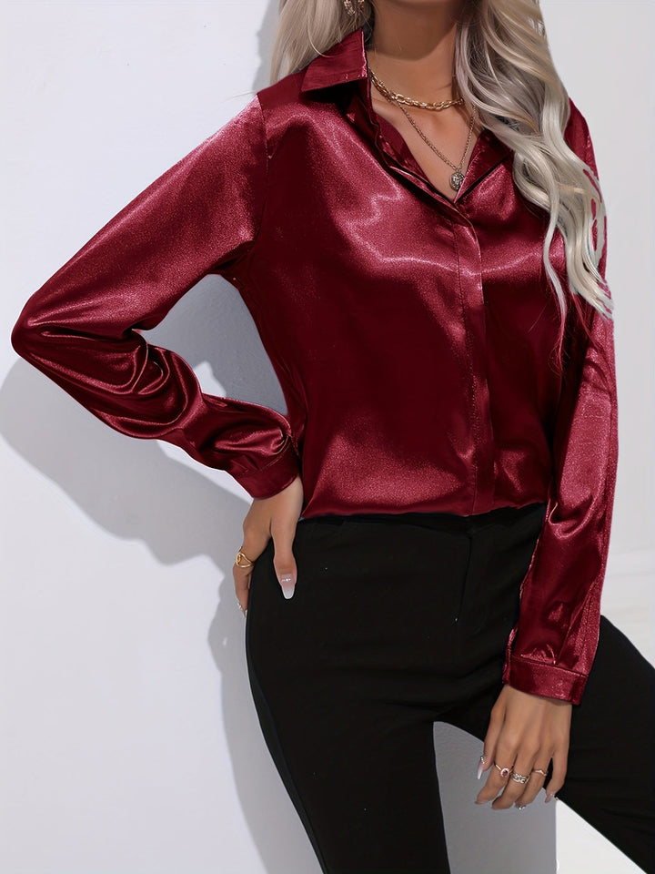 Fashion-forward women's button-down long-sleeve satin blouse with a relaxed fit, great for modern styling.