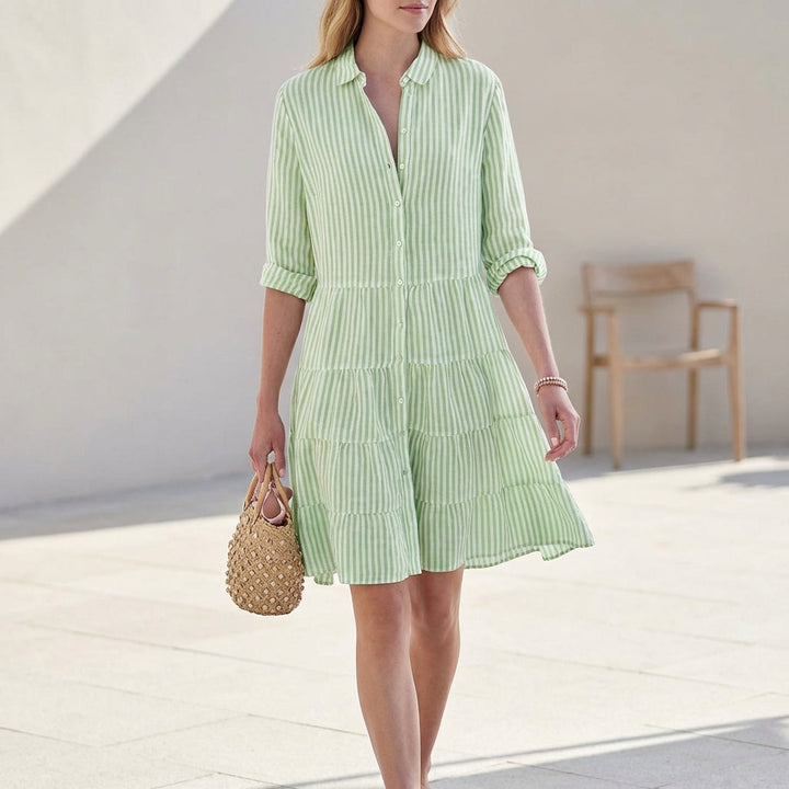Elegant women's button-down tiered mini dress with V-neck and 3/4 sleeves, perfect for spring/summer fashion.