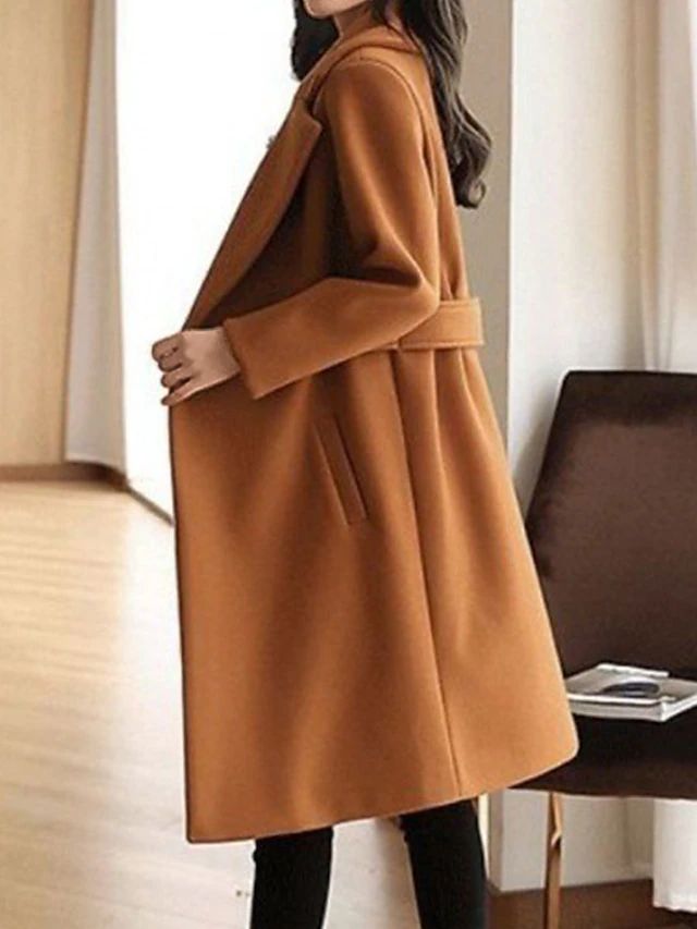 Fashionable women's brown long sleeve winter coat with a stylish belt, formal outerwear.