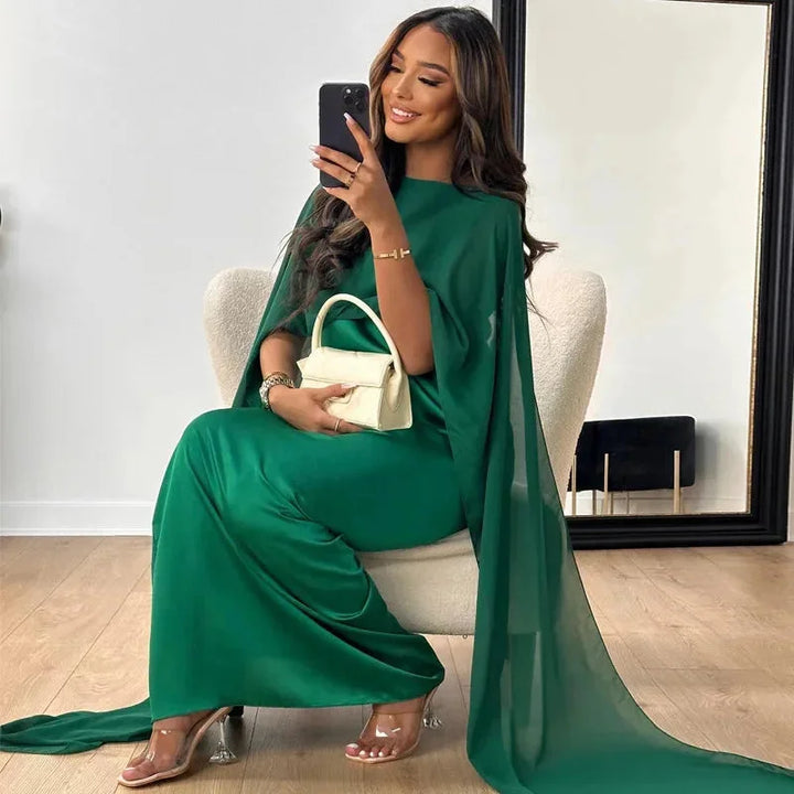 Glamorous women's wedding guest dress with a chic cape design, offering an elegant and fashionable look.