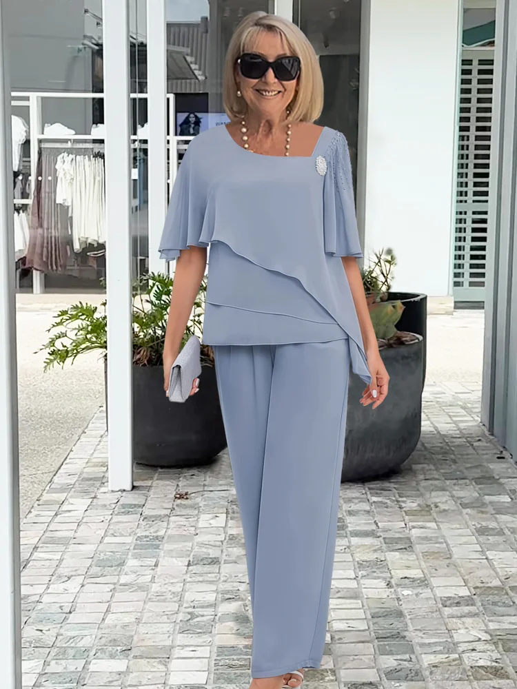 Navy blue formal two-piece set: chic cape top & straight leg pants. Ideal elegant ensemble for special events.