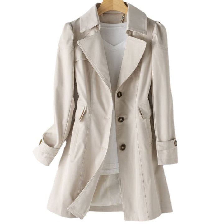 Fashionable women's double-breasted trench coat, a classic jacket for an elegant look in cooler weather.