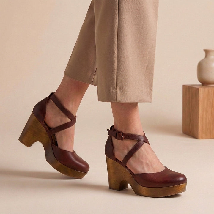 Comfortable women's closed-toe block heel pumps with an elegant ankle strap, perfect for formal and stylish footwear.