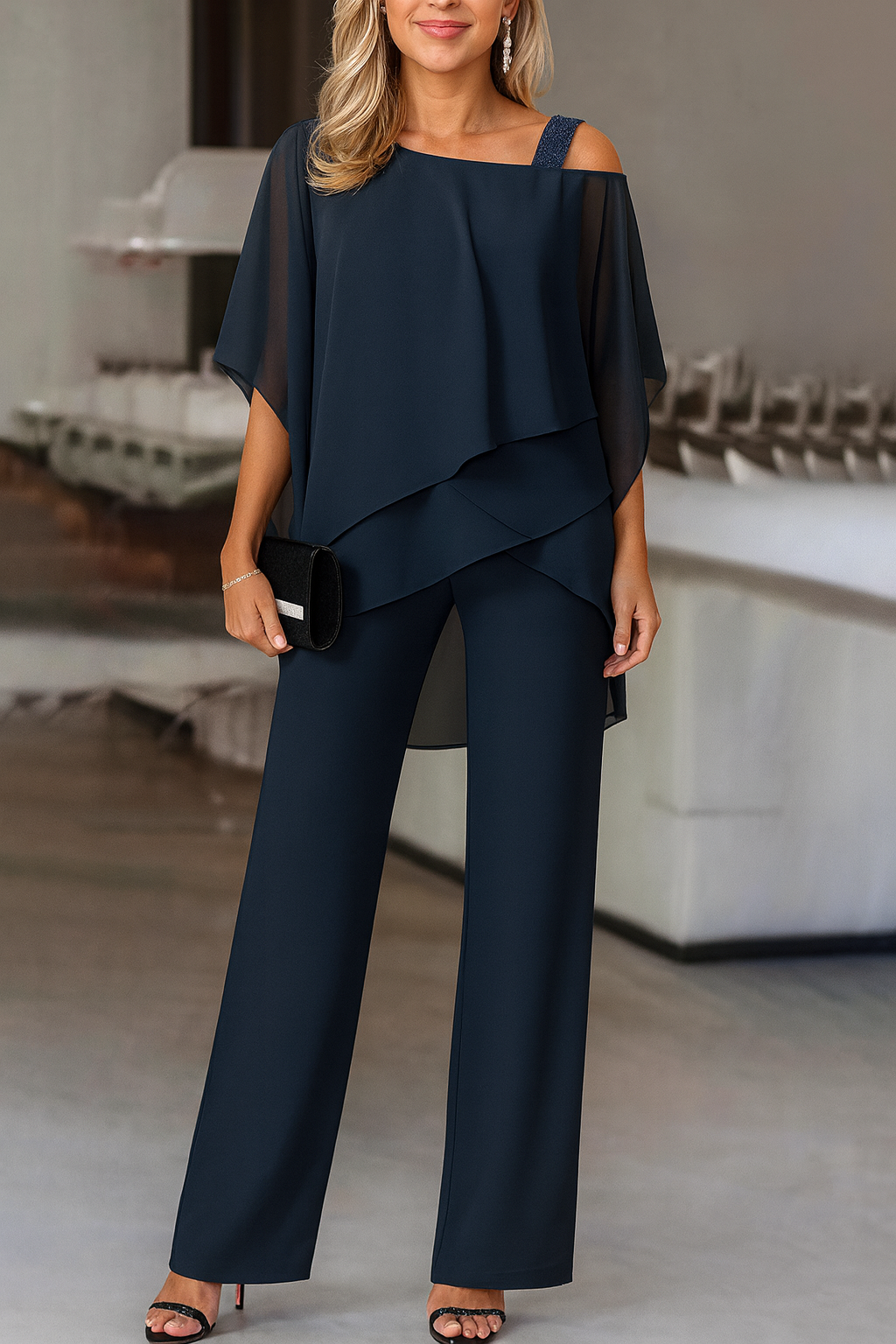 Fashionable women's cold-shoulder two-piece pants set. Elegant and comfortable apparel for various events.