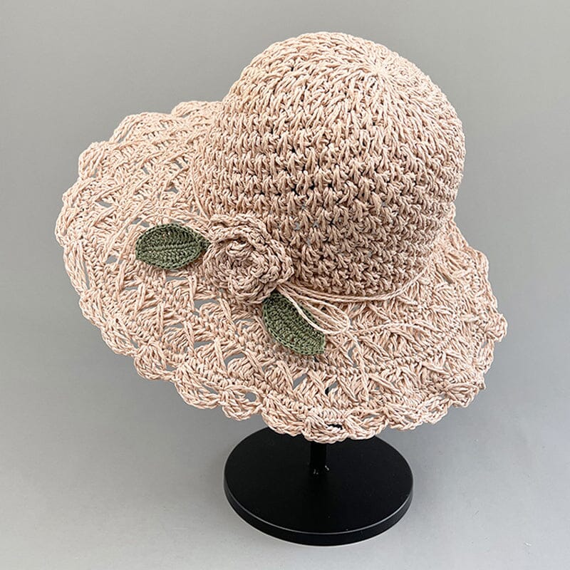 Elegant women's straw sun hat with a unique crochet pattern and a delicate, flowing ruffle.