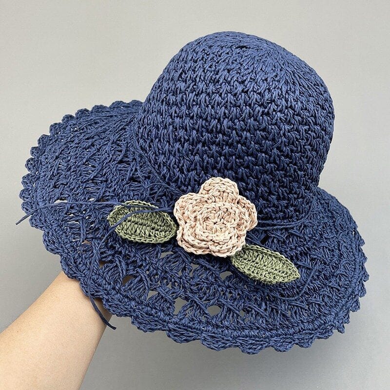 Chic women's straw sun hat with a distinctive crochet texture and feminine ruffle detail.