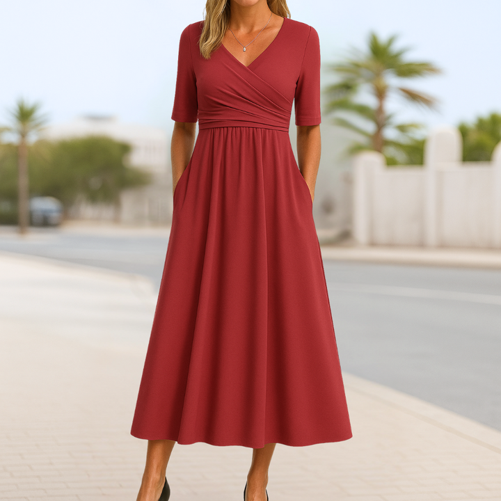 Comfortable women's midi dress featuring a crossed V-neck, short sleeves, and flowy flared skirt for versatile style.